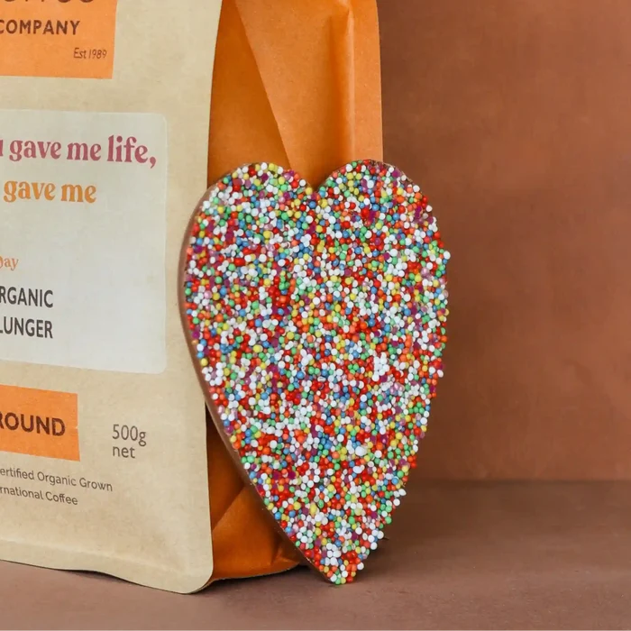 Coffee bag from Byron Bay Coffee Company with a colorful heart-shaped object on a brown background
