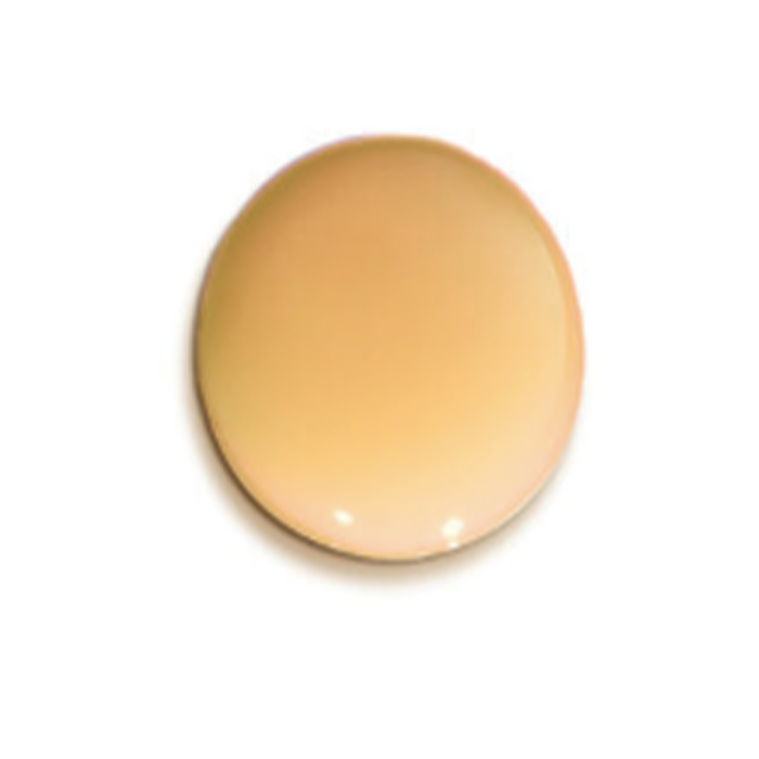 A smooth, circular fluid drop swatch of Ayuna Eye Serum, showcasing its lightweight, translucent peach-amber tint.