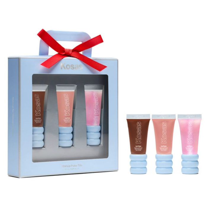 Kosas 3-piece lip care gift set in a light blue box with a red ribbon handle, shown alongside the three individual lip products (brown, peach, and pink) on a white background.