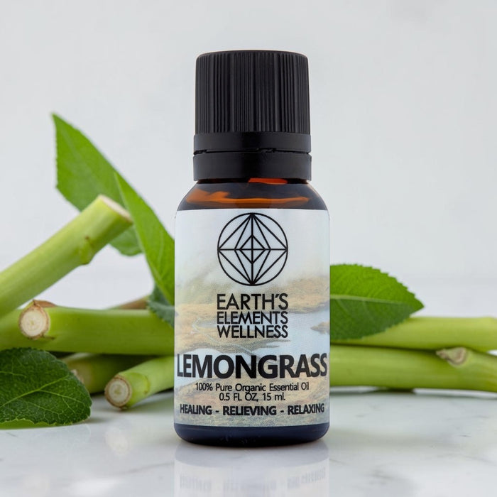 Bottle of Earth's Elements Wellness Lemongrass essential oil with lemongrass leaves in the background.
