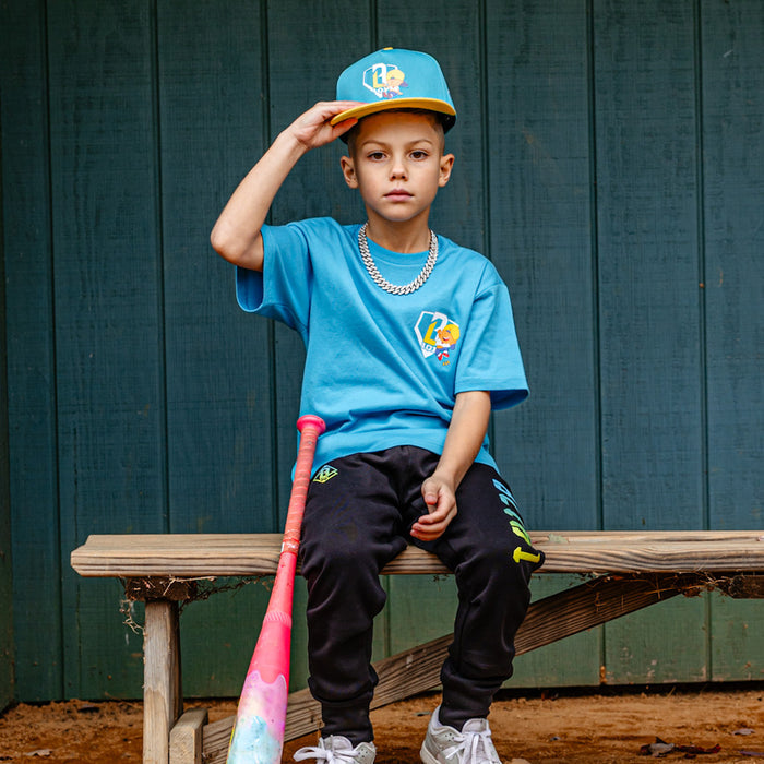 Youth model wearing blue youth graphic tee with “Pablo Power” design