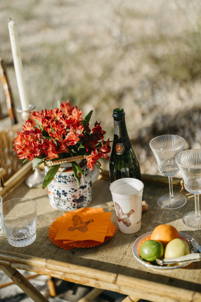 Set of four orange beverage napkins with pheasant design by Alexa Pulitzer, perfect for elegant gatherings and outdoor events.