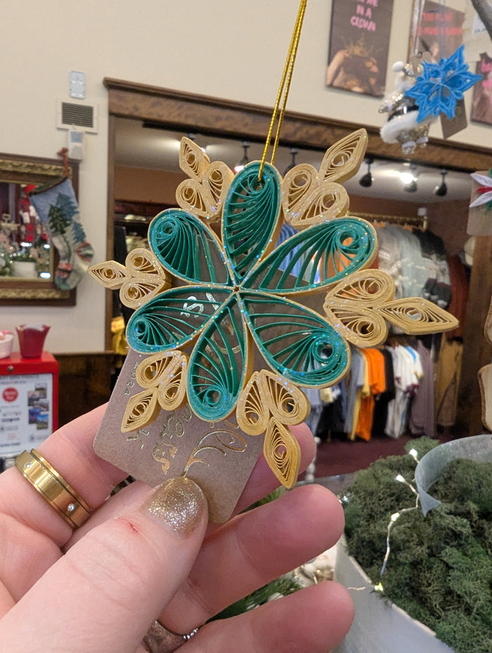 Colorful quilled ornaments by Cat's Quilling featuring intricate paper designs, perfect for decorating or gifting.