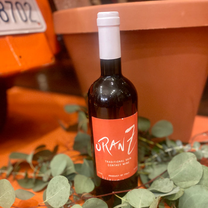 Wine bottle with dark glass and orange label, white cap