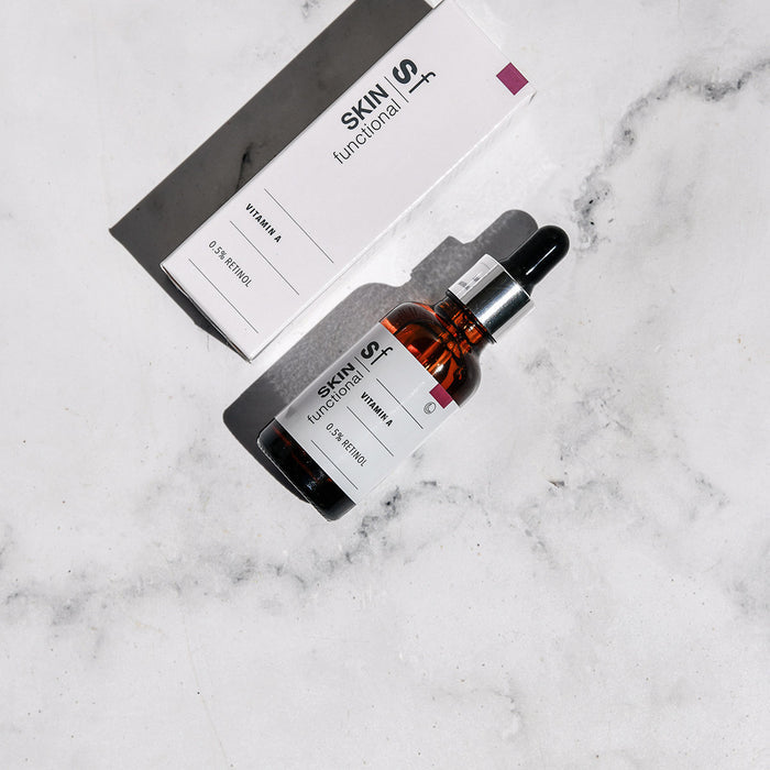 SKIN Functional vitamin A treatment with details skincare product on a grey background