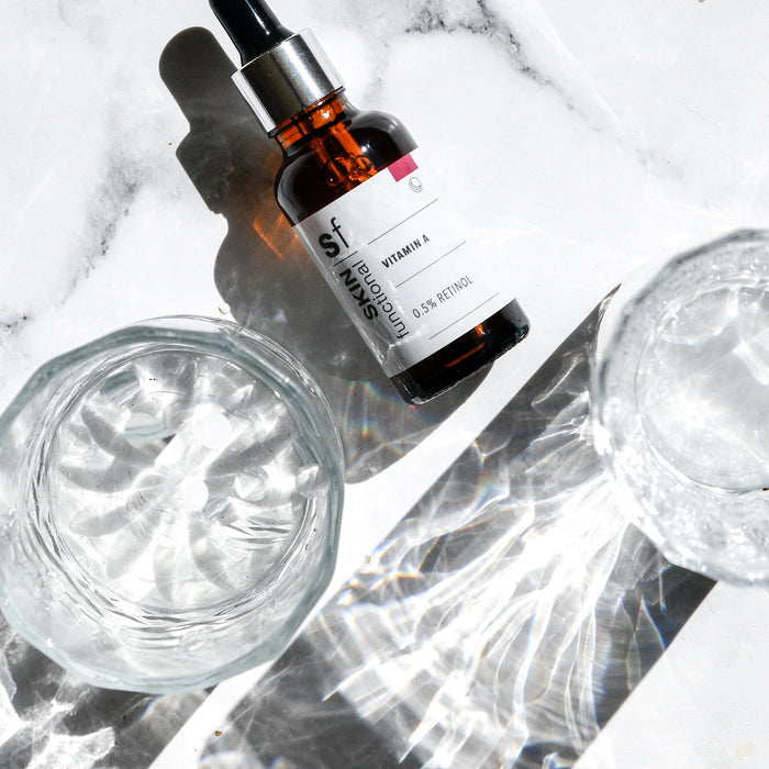SKIN Functional vitamin A treatment with details skincare product on a grey background