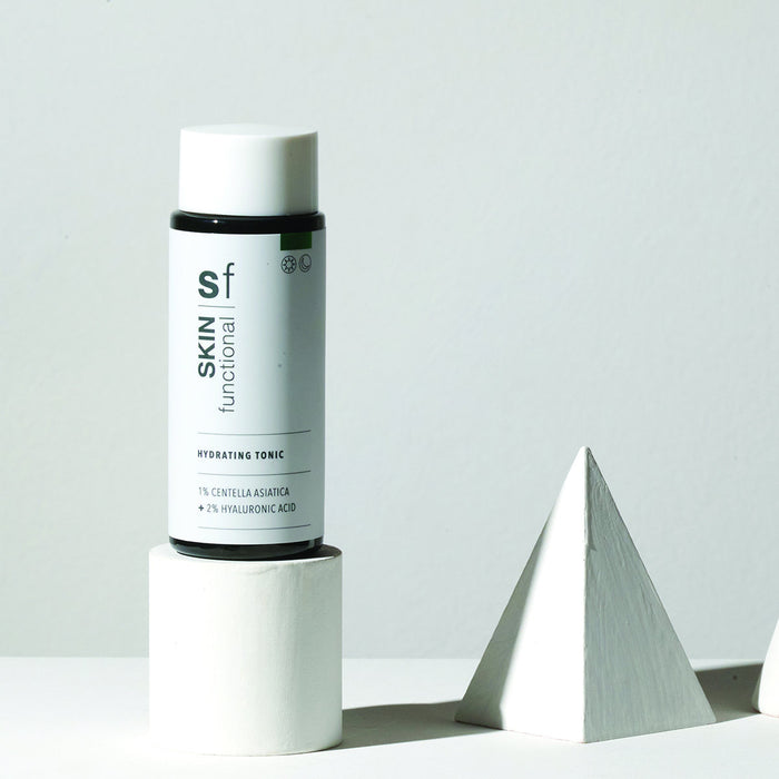 SKIN Functional Hydrating Tonic with details skincare product on a light gray background