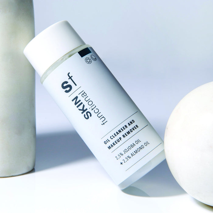 SKIN Functional Oil Cleanser and Makeup Remover with details skincare product on a light gray background