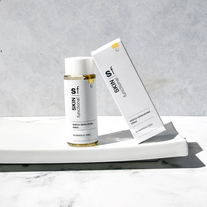 SKIN Functional gentle exfoliating tonic with details skincare product on a grey background