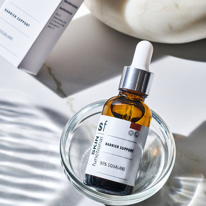SKIN Functional carrier support skin treatment with details skincare product on a grey background