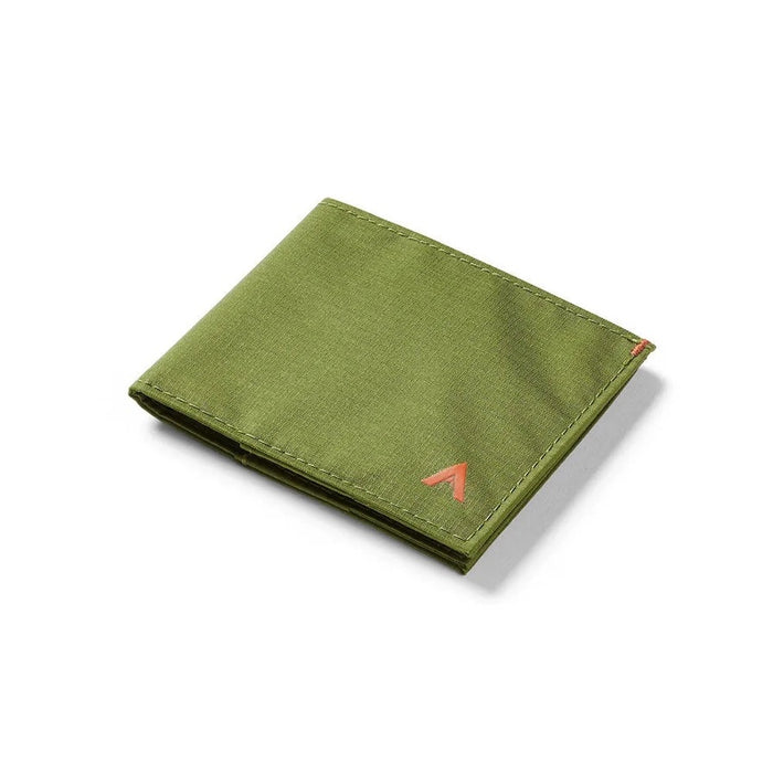 A close-up of the ALLETT Sport Wallet in Cala Green shows its green RFID-blocking ripstop nylon, visible stitching, and a white card partially tucked into one pocket.