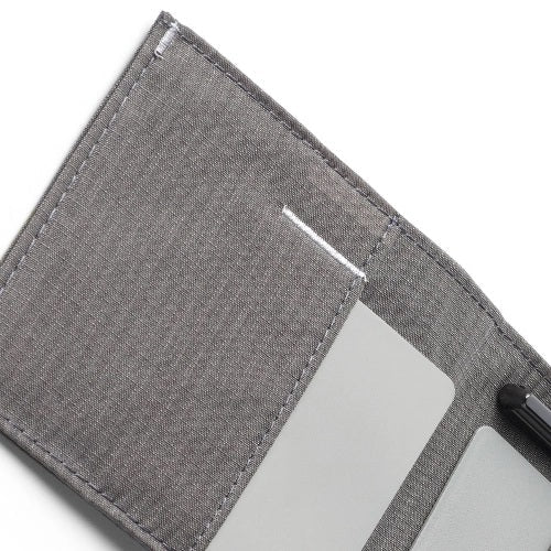 The ALLETT Sport Wallet in RFID-blocking charcoal grey nylon features subtle grid lines and a small white triangular logo on the lower right, shown closed on a white background.