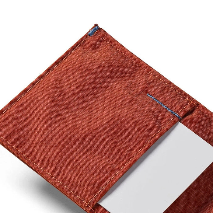 Beads of water on the ALLETT Sport Wallet in RFID-blocking nylon (Potter’s Clay) show its water-resistant, ripstop fabric and minimalist design.