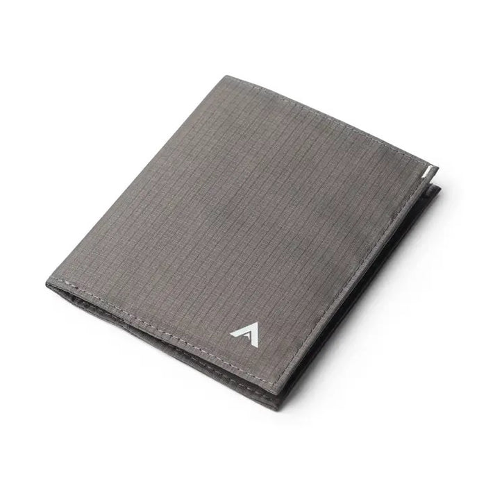 The ALLETT Original Wallet in RFID-blocking charcoal grey nylon features a minimalist design with a grid pattern and small white triangular logo, shown closed against a white background.