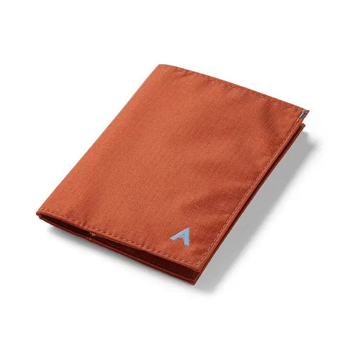 An ultra-slim, closed ALLETT wallet in RFID-blocking Potter’s Clay nylon, featuring a small gray or light blue "A" logo on the bottom right, shown on a white background.