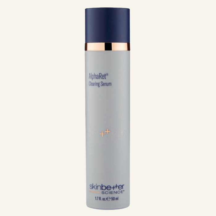 Skin Better Science AlphaRet Cleansing Serum in a tall 1.7oz cylindrical bottle with a light gray body, dark navy blue cap, and a metallic gold collar, shown on a light off-white background.
