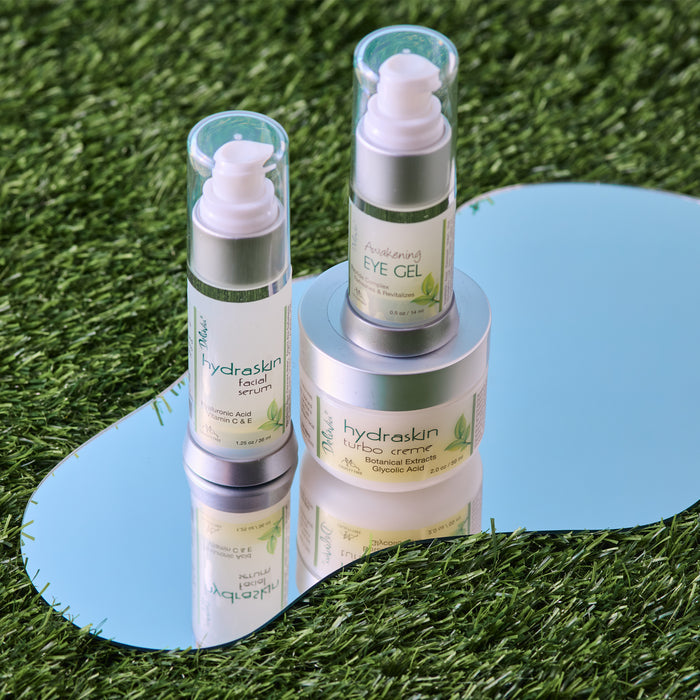 Deluvia Facial Serum and Awakening Eye Gel, and Turbo Creme on a mirror.