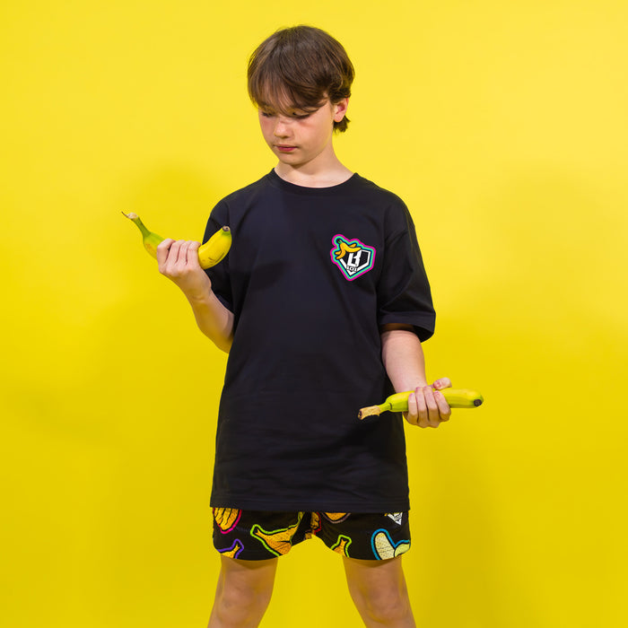 Youth model wearing black Banana Neon youth graphic tee