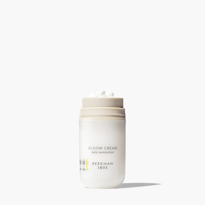 Bottle of Beekman 1802's Bloom Cream Daily Moisturizer Regular on a white background.
