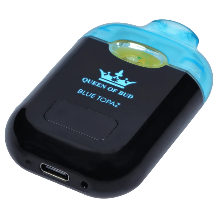 Angled close-up of the Blue Topaz Liquid Crystals Disposable Vape showing its glossy black body, translucent blue mouthpiece, and centered crown logo.