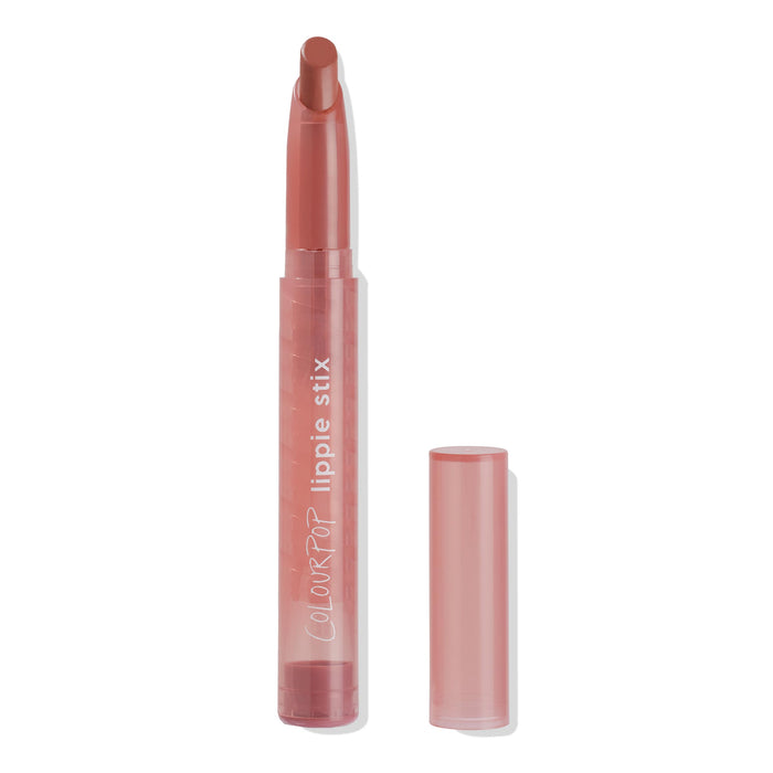 ColourPop Lippie Stix Brink stands uncapped, revealing a warm rosy terracotta lipstick bullet in a slim translucent pink tube labeled “lippie stix,” with the cap placed beside it on a clean white background.