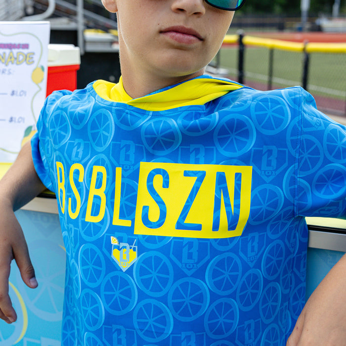 Youth model wearing blue youth short sleeve hoodie with "BSBL-SZN V3" design