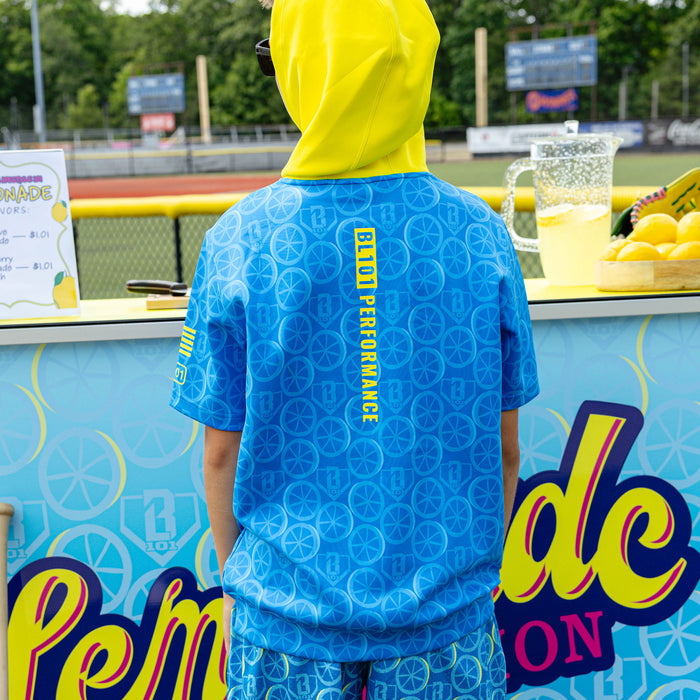Youth model wearing blue youth short sleeve hoodie with "BSBL-SZN V3" design
