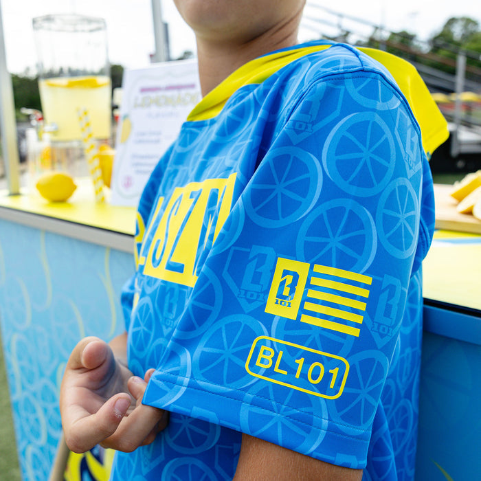 Youth model wearing blue youth short sleeve hoodie with "BSBL-SZN V3" design