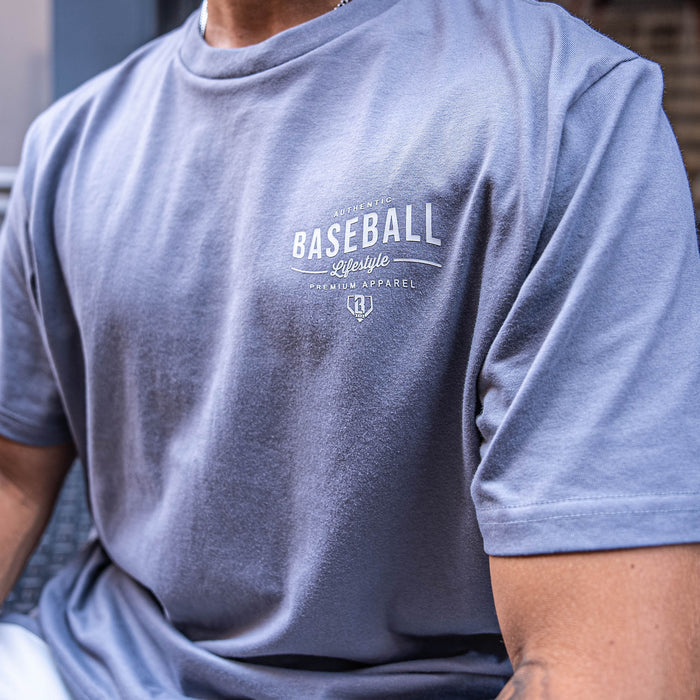 Person wearing a gray t-shirt with 'Baseball Lifestyle' text and logo.