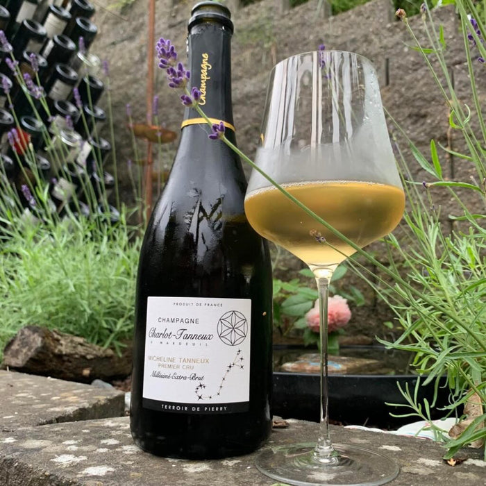 Champagne bottle with flute glass of extra brut sparkling wine, 2014