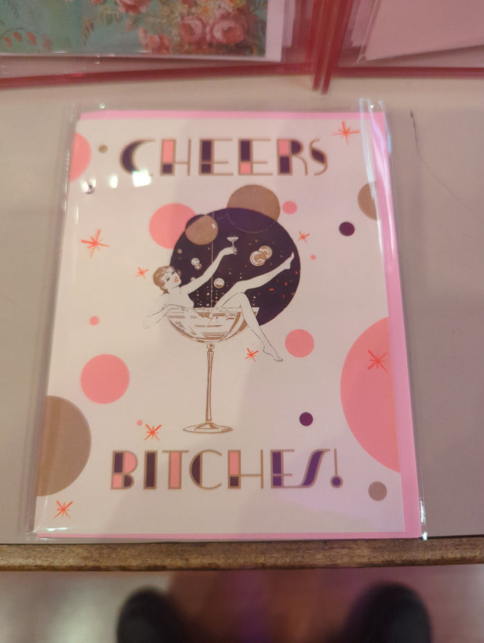 OffensiveDelightful Cheers Bitches! card featuring bold black text on a white background, perfect for humorous greeting cards.