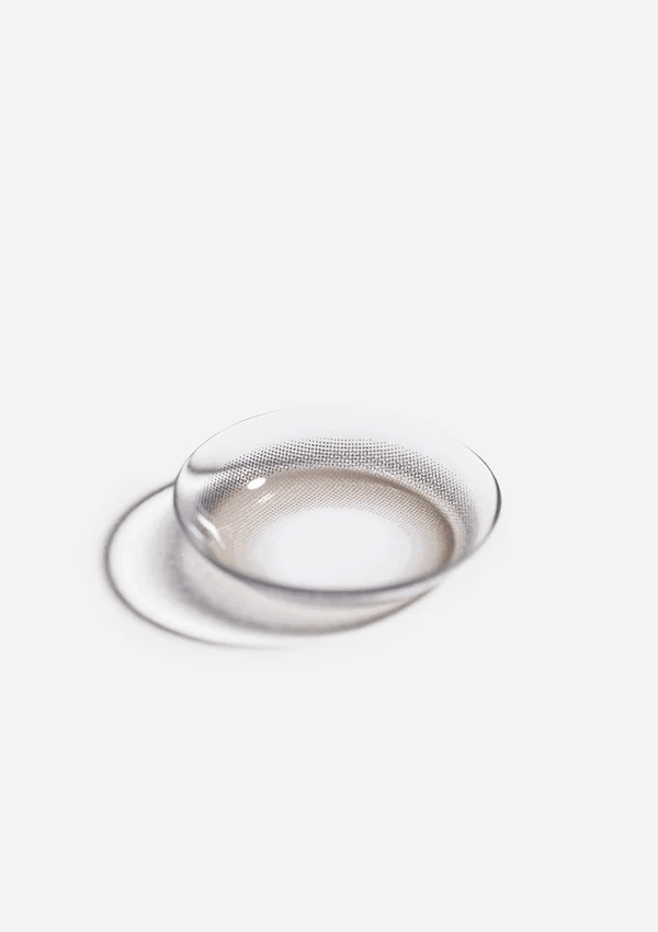 Macro photo of the Eyecandys Aery Rose Lucid Grey prescription colour contact lens, showcasing the thin material and cosmetic lens design.
