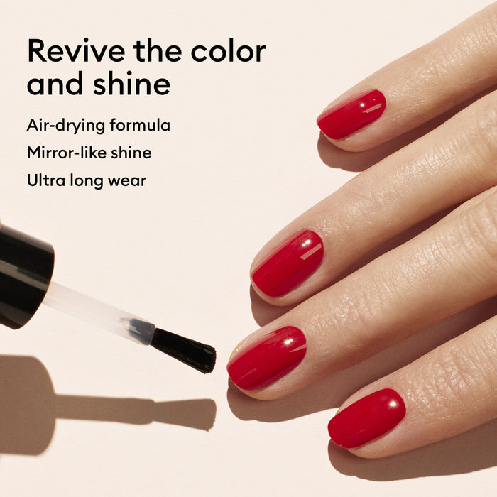 A hand with neatly manicured red nails is shown as a black-handled brush applies Manucurist Color Refresher. Text: Revitalizes color and shine. Air-drying formula for quick touch-ups. Mirror-like shine. Ultra long wear.