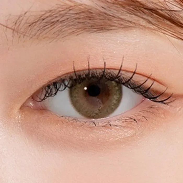 Macro shot of an eye wearing the DooNoon Bono Brown prescription colour contact lens, showing the multi-colored detail and natural effect on dark brown eyes.