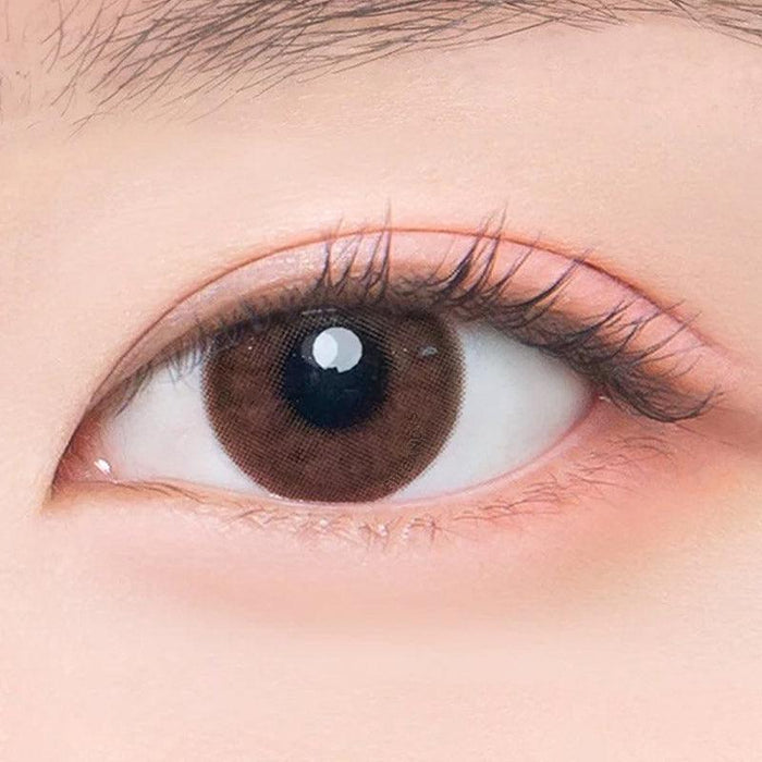 Macro shot of an eye wearing the DooNoon Epic 1-Day Brown (10pk) prescription colour contact lens, showing the multi-colored detail and natural effect on dark brown eyes.