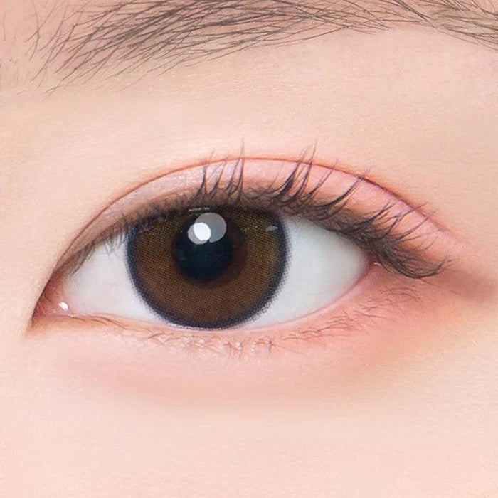 Macro shot of an eye wearing the DooNoon I On Lime Brown prescription colour contact lens, showing the multi-colored detail and natural effect on dark brown eyes.