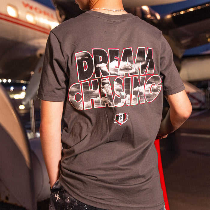 Youth model wearing gray Dream Chaser Red Eye youth graphic tee