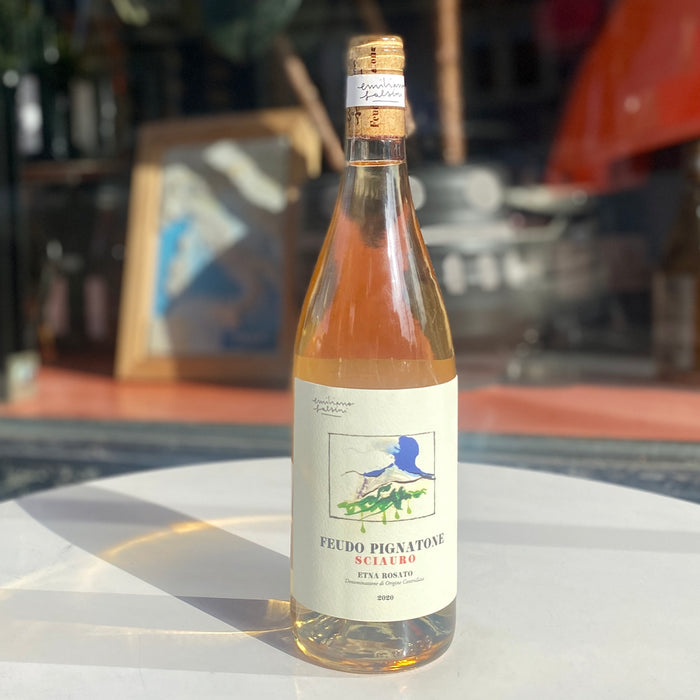 Rosato wine bottle with peach-pink liquid and illustrated front label