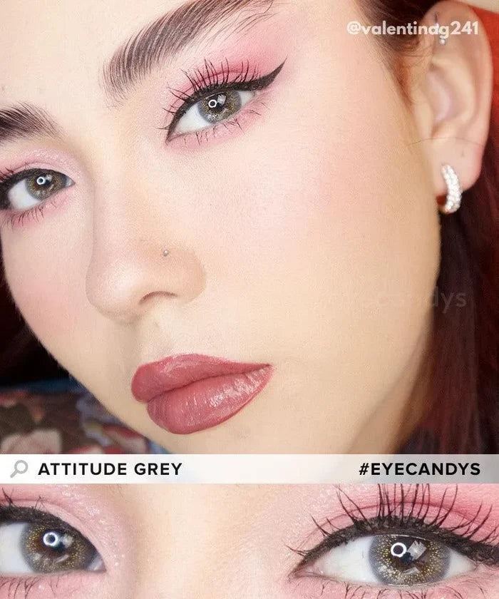 Close-up of a person wearing pink eyeshadow, winged eyeliner, bold mauve lipstick, and EyeCandys Attitude Glitter Grey colored contacts. Text: "EyeCandys Attitude Glitter Grey" and "#EYECANDYS".