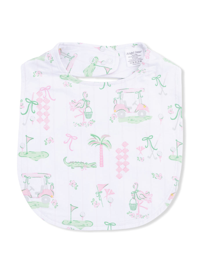 White bib featuring a playful print of golf-themed icons, flowers, and palm trees in pastel colors.