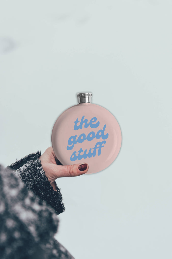 Stainless steel Flask from The Good Stuff by Soiree Sisters, with a sleek, reflective surface and compact design for portable use.