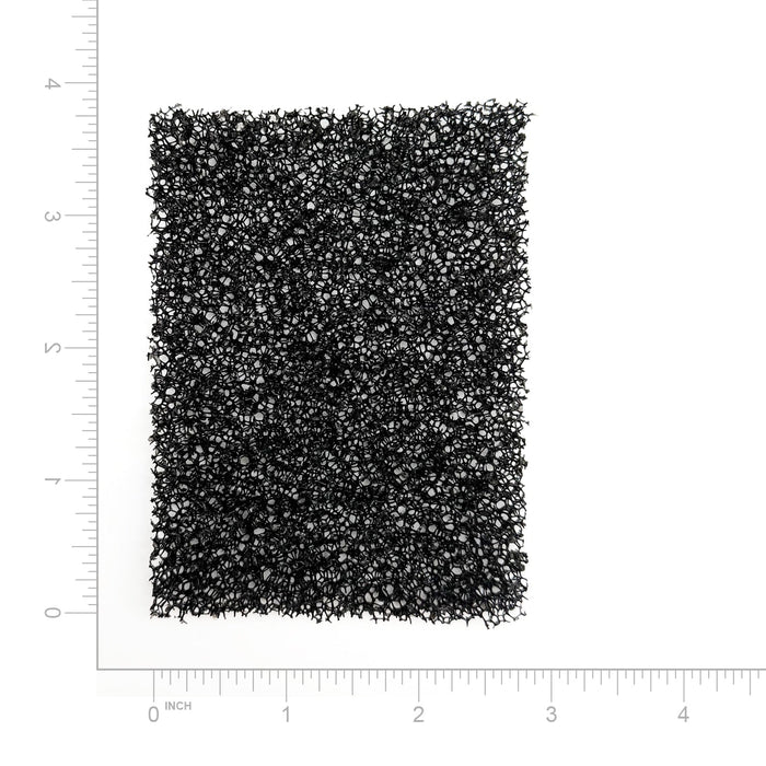 Textured black filter on a white background with measurement scale
