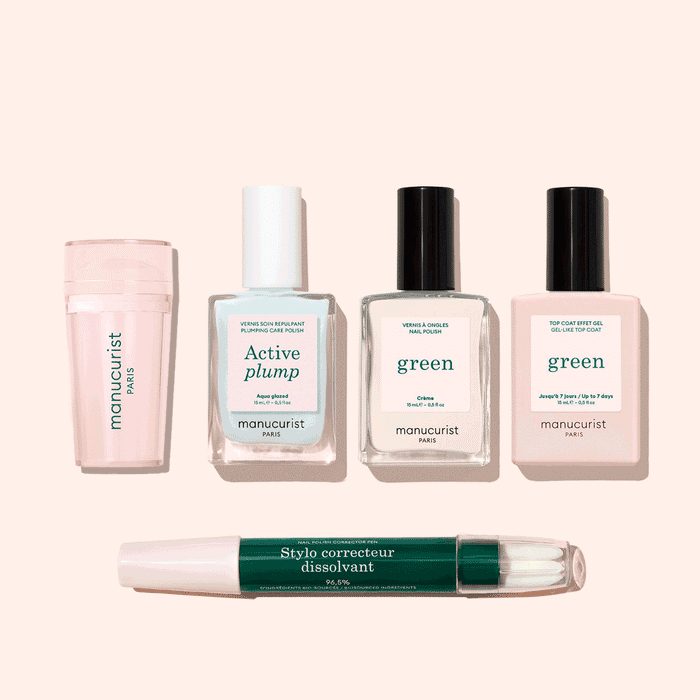 Five manicure products from Manucurist’s French Active™ Kit are shown on a beige background: a pink cylindrical container, a square bottle labeled Active blur, two green-labeled nail polish bottles, and a dual-ended Stylo correcteur pen.
