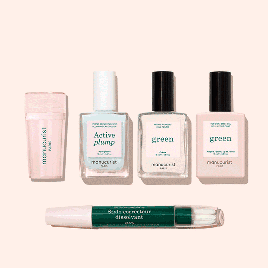 Five manicure products from Manucurist’s French Active™ Kit are shown on a beige background: a pink cylindrical container, a square bottle labeled Active blur, two green-labeled nail polish bottles, and a dual-ended Stylo correcteur pen.