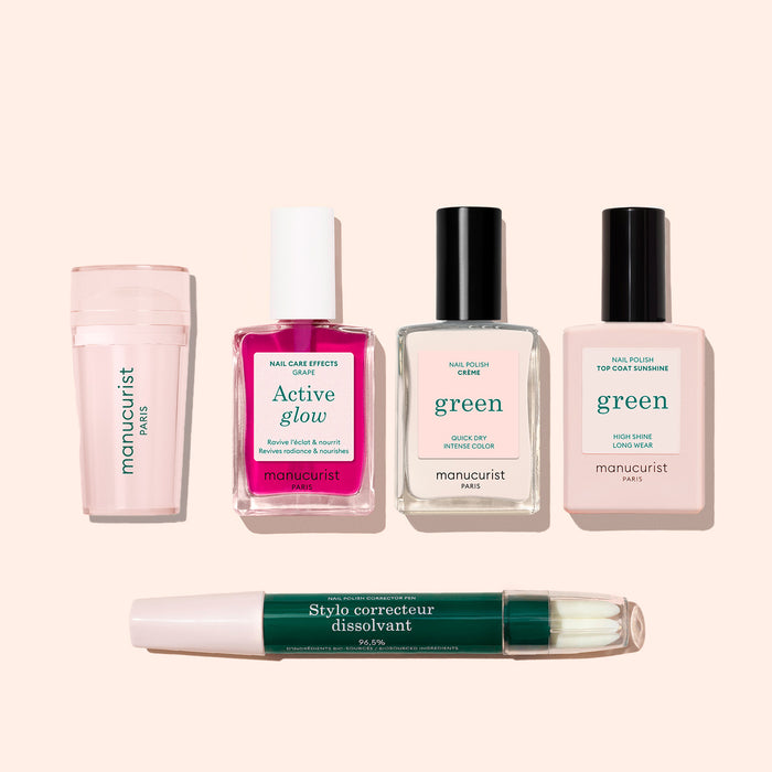 Five manicure products from the Manucurist French Active™ Kit on a light beige background: nail file, pink nail care serum, remover, two pale pink polishes for French tips, and a green  white corrector pen.