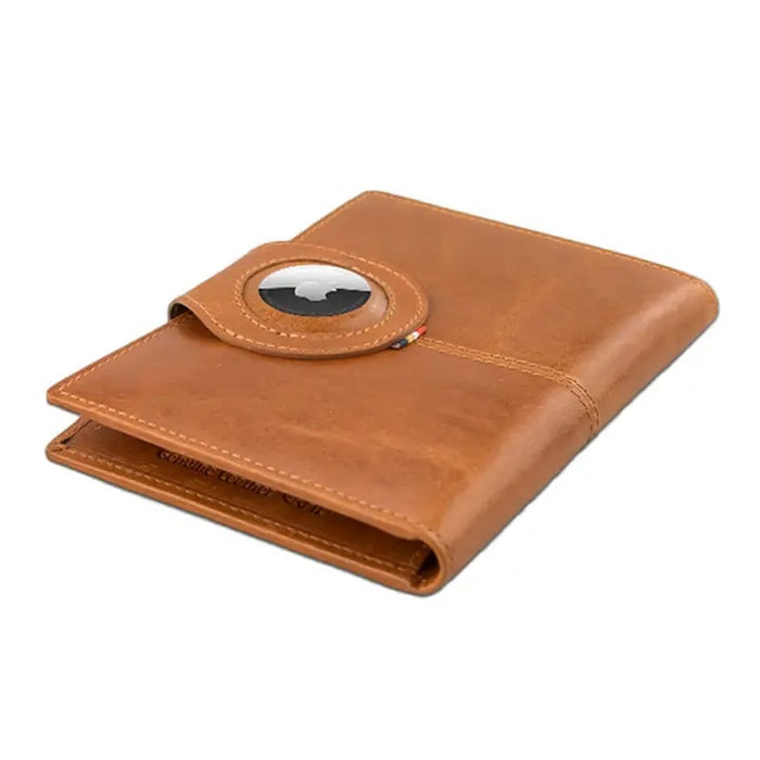 The GARZINI RFID-blocking leather passport holder in cognac features an AirTag compartment and opens to reveal card slots, a pen, and a burgundy passport—combining security with elegant organization.