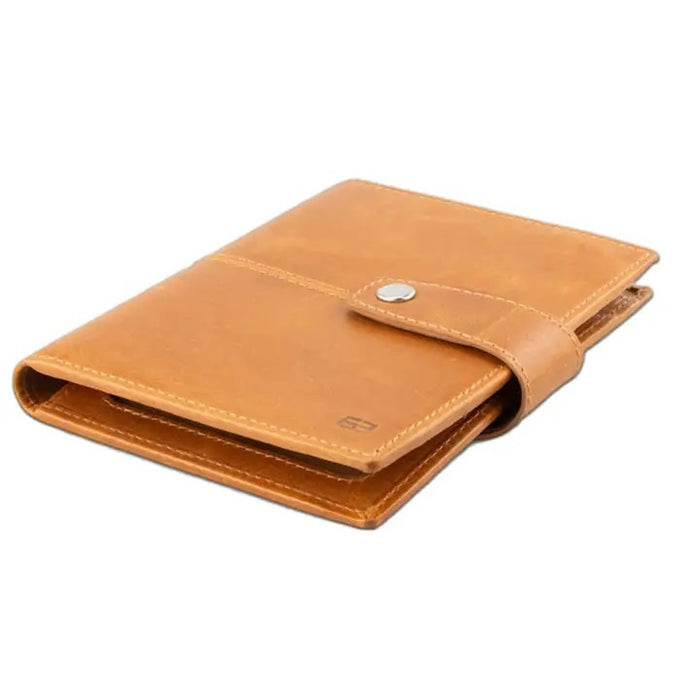 The GARZINI RFID-blocking leather passport holder in cognac features an AirTag compartment and opens to reveal card slots, a pen, and a burgundy passport—combining security with elegant organization.