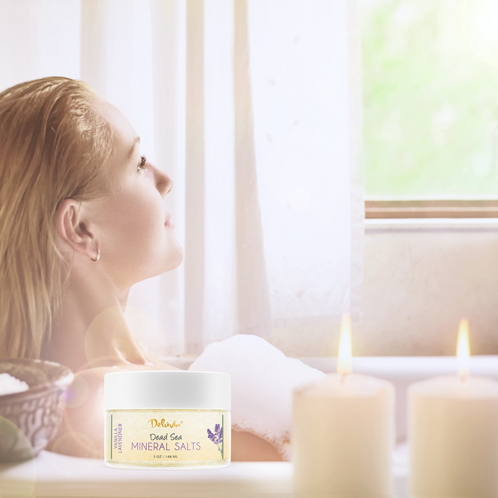 Woman in bathtub with Deluvia mineral salts in the foreground.