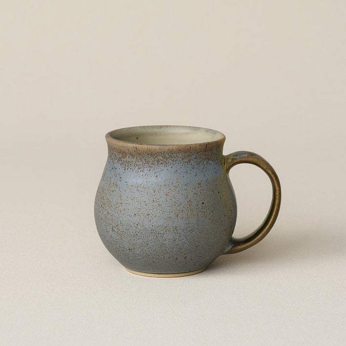 Hand-thrown ceramic mug by Rookwood Pottery