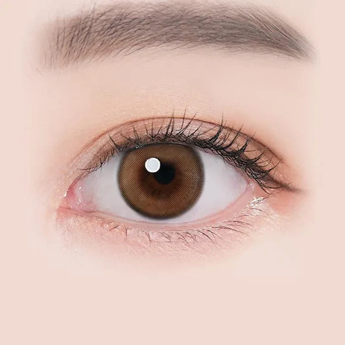 Macro shot of an eye wearing the i-Sha Ariel Brown prescription colour contact lens, showing the multi-colored detail and natural effect on dark brown eyes.